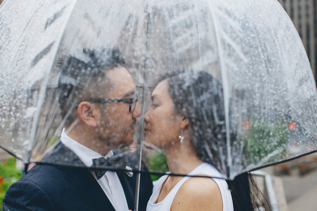 Bride & Groom under clear umbrella in the rain | Toronto City Hall Wedding | EIGHTYFIFTH STREET PHOTOGRAPHY