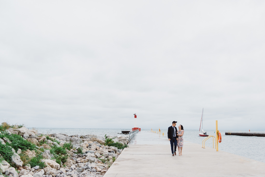 Couple walking along pier | EightyFifth Street Photography