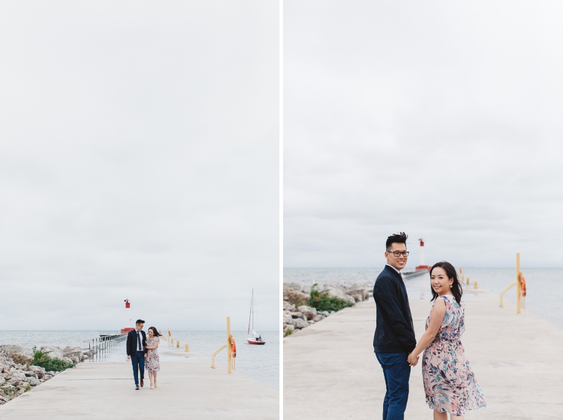 Couple walking along pier | Oakville Lakeside Park Engagement | EightyFifth Street Photography