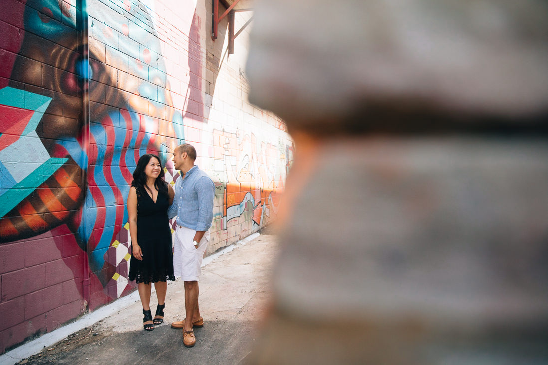 Couple laughing in graffiti alleyway | Kensington Market Engagement, Toronto | EightyFifth Street Photography