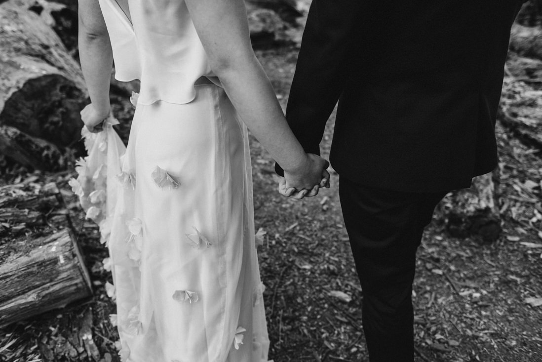 black & white photo of bride & groom holding hands | eightyfifth street photography