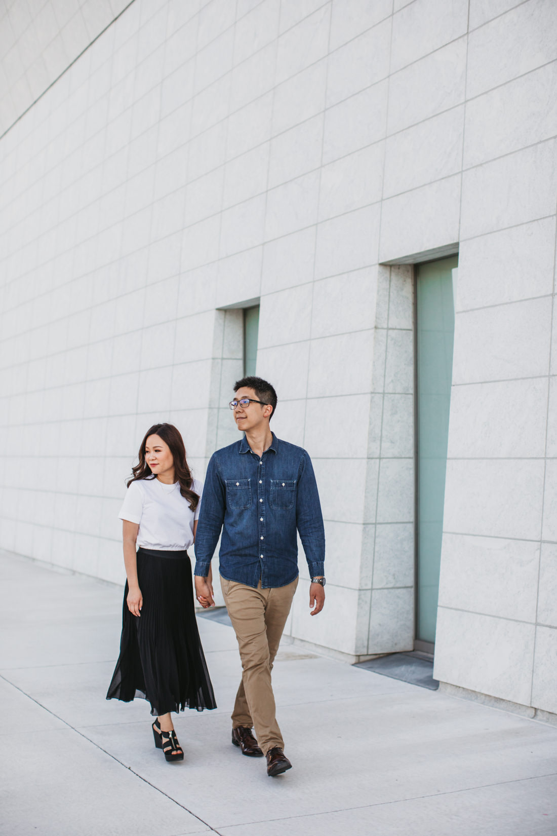 Couple Walking outside modern building | Aga Khan Museum engagement | Minimalist portrait location | Toronto Wedding Photographer | EightyFifth Street Photography