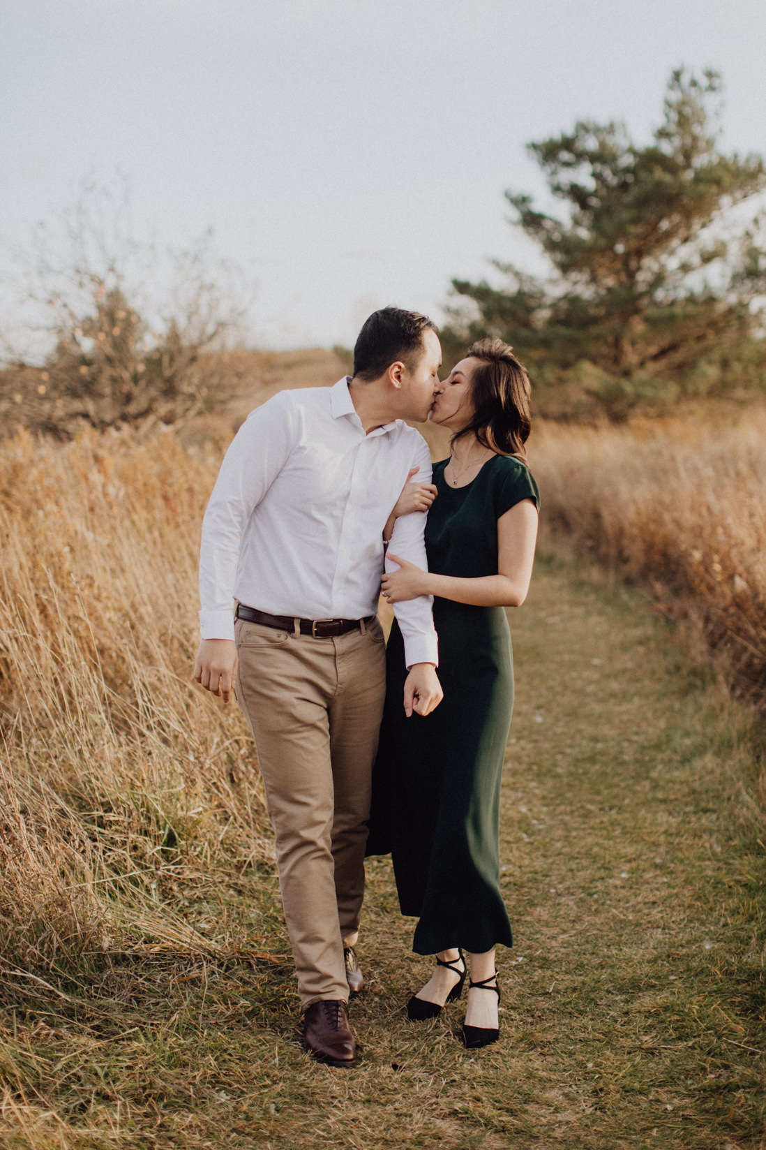 couple kissing mid walk fall engagement | eightyfifth street photography