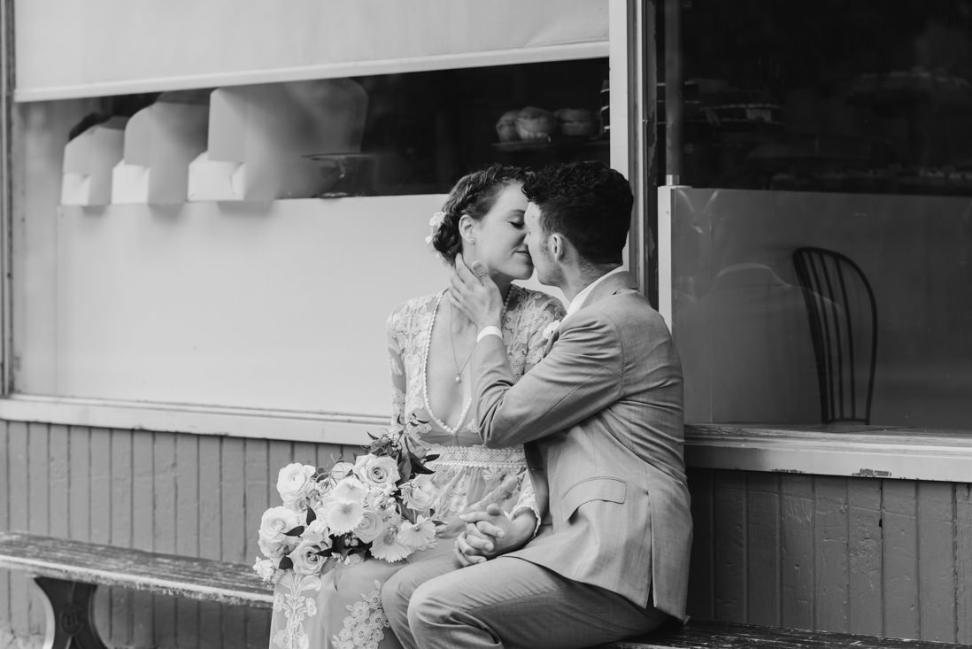bride and groom kissing in front of bakery Toronto_EightyFifth Street Photography