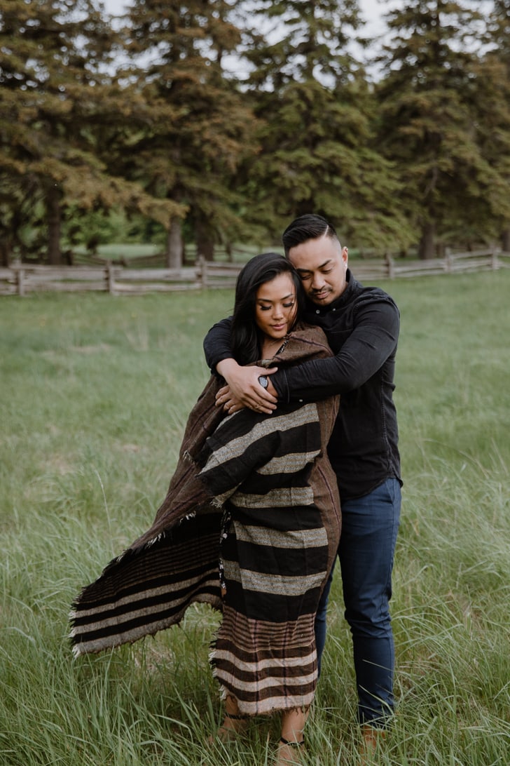 A couple embraces in a field during their Scotsdale Farm engagement session.